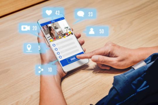 woman share view of beauty blogger review online with mobile apps on wood table at home,online influencer technology in daily lifestyle,Digital age concept