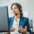 Friendly woman in call center service talking with costumers by headset. Call center and diverse people group in business.